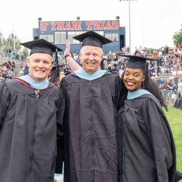 Graduating students standing together smiling