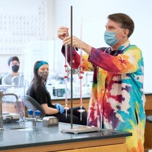 Action shot of a teacher mid science experiment