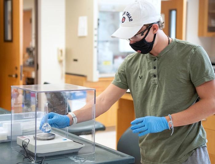 student works on science experiment